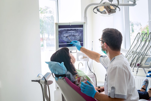 Dentist showing x-ray to patient.